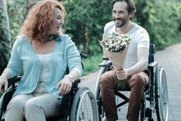 istock Delighted brunette presenting flowers to his woman 936841936
