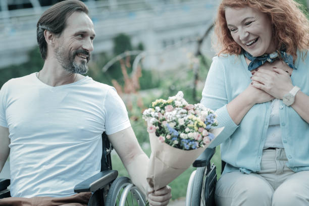istock Positive delighted girlfriend looking at flowers 936842050