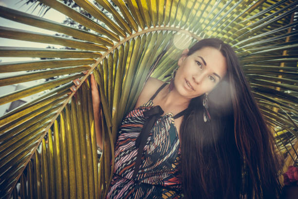 istock Beautiful woman in palm leaves 936842638