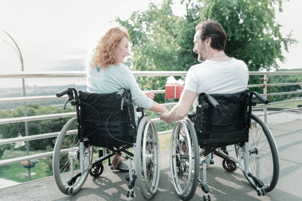 istock Delighted invalid man giving present to his girlfriend 936842730
