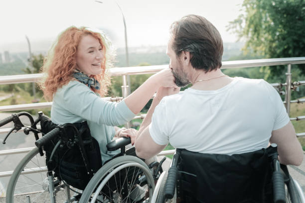 istock Happy differently abled couple sitting on their wheelchairs 936842778
