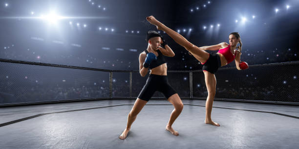 istock Female MMA fighters in professional boxing ring 936850060