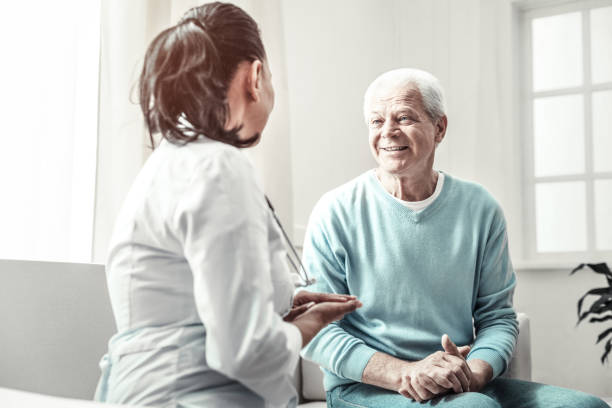 istock Senior nice-looking man smiling and having consultation 936850510