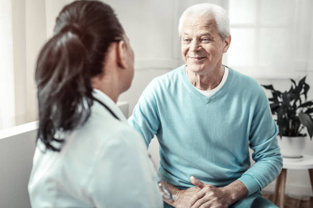 istock Senior pleasant man sitting and looking at the doctor 936850694