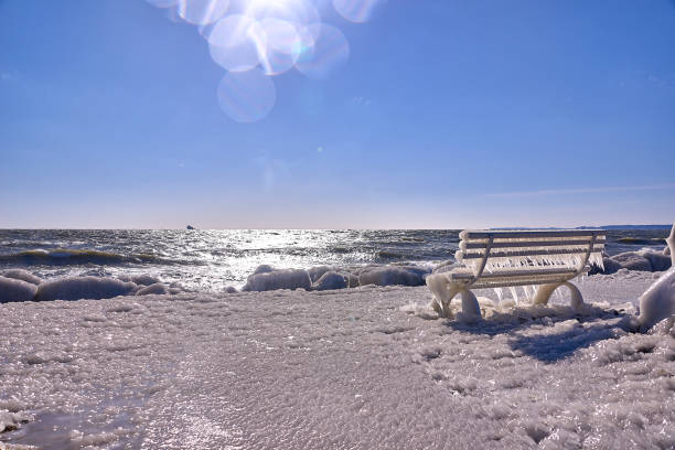 istock frozen lighthouse and pier on stormy winter day 936850768