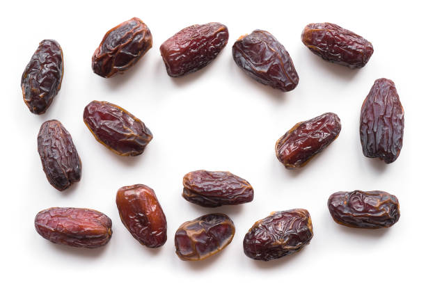 Isolated Big Sweet Dates with copy space. Top view. Isolated Medjool Dates on white background. Fruit pattern. date fruit stock pictures, royalty-free photos & images