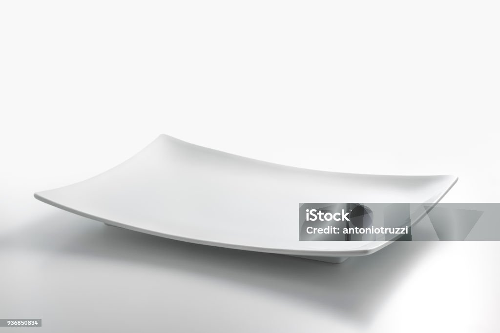 Empty white rectangular plate Empty white rectangular plate isolated on white table Plate Stock Photo