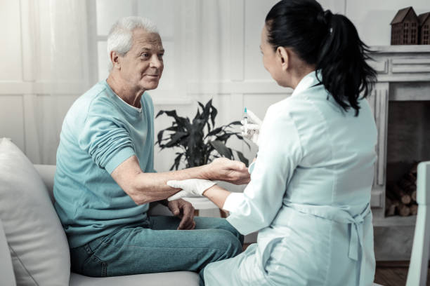 istock Pleasant kind man looking at the doctor giving her arm 936854574