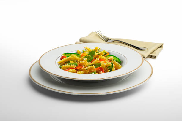 istock Pasta dish Fusilli and vegetables with napkin and fork 936854986