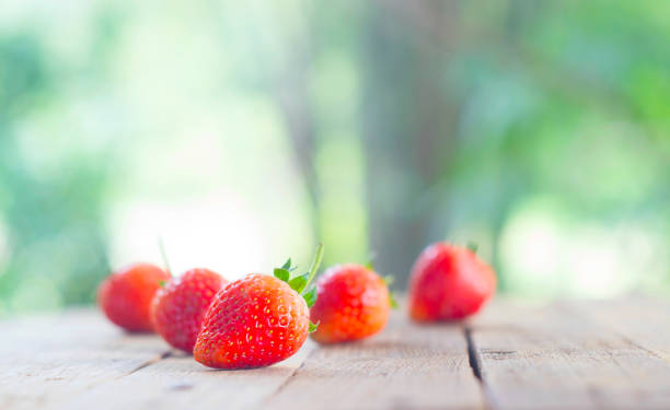 istock background from freshly harvested strawberries on wood table, directly above 936855224