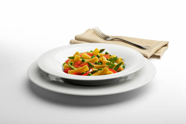 istock Pasta dish Macaroni and vegetables with napkin and fork 936855432