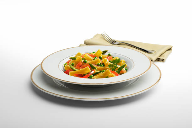 istock Pasta dish Macaroni and vegetables with napkin and fork 936855570