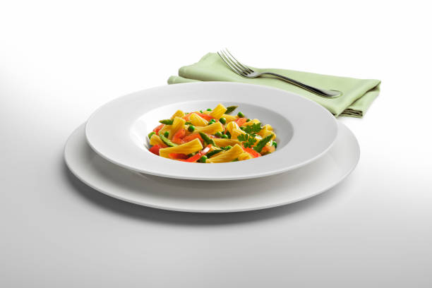 istock Pasta dish Macaroni and vegetables with napkin and fork 936855658