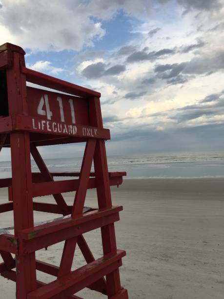 istock Red lifeguard stand at low tide at New Smyrna Beach 936859310