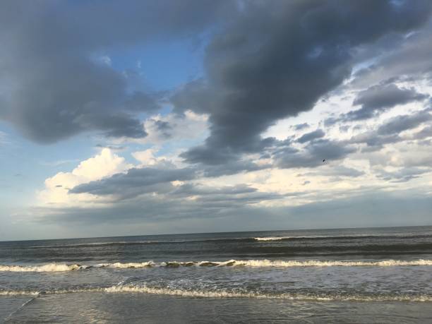 istock Cloudy sky reflected on the sand at New Smyrna Beach 936861488