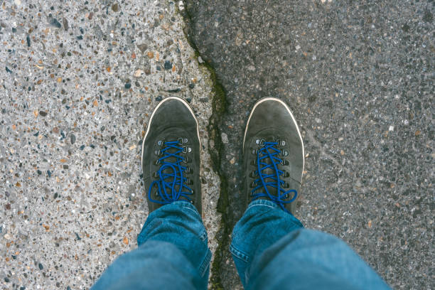 istock Concept of facing a crucial decision shown by shoes on different colored pathways 936872662