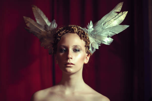 istock redhead girl in feather headdress 936875734