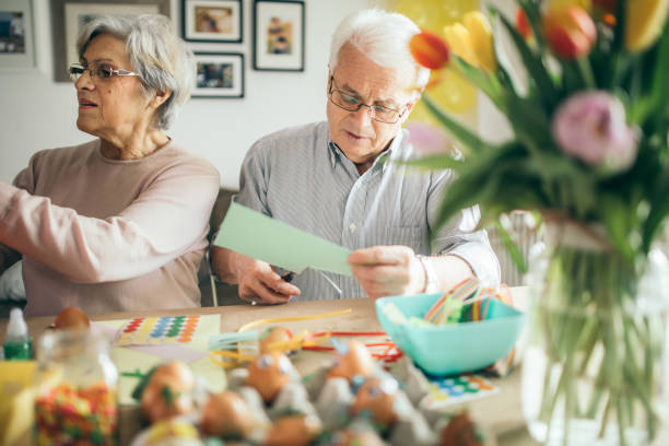 istock Seniors decorating for festival 936876800