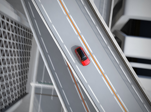 Aerial view of metallic red electric SUV driving on the highway. 3D rendering image.