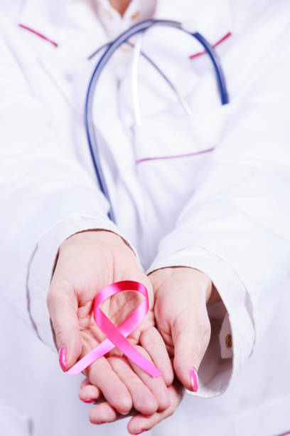istock Female hands with pink ribbon 936883056