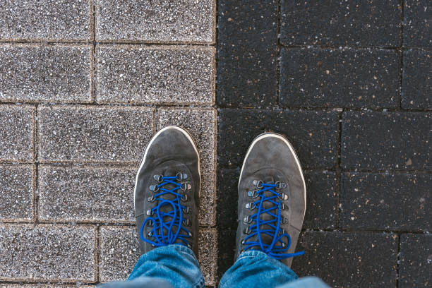 istock Concept of facing a crucial decision shown by shoes on different colored pathways 936885808