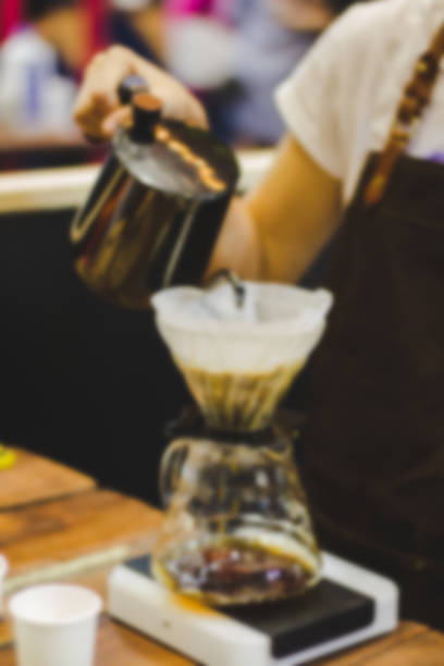 istock Blurred image guy is pouring hot water to make coffee. 936886250