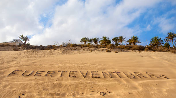 the word Fuerteventura written with pebbles on the sand of a beach in Fuerteventura, Canary Islands, Spain