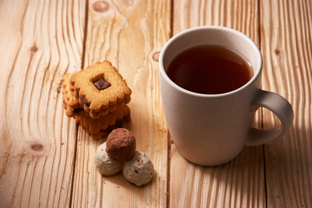 istock tee and cookies on a wooden table 936887046