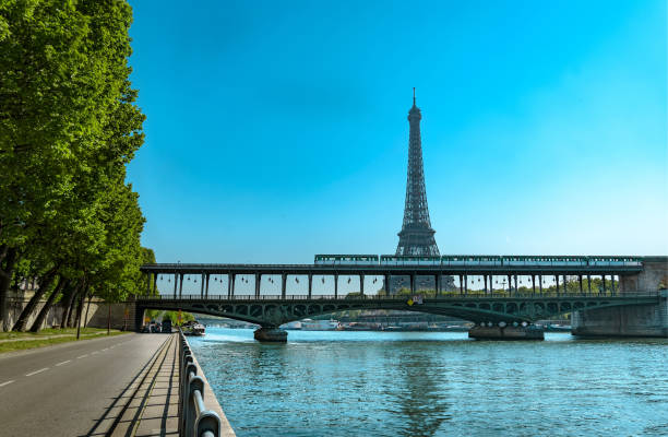 istock World Famous Structure Eiffel Tower and Bir-Hakeim Bridge with Subway Metro Train Passing Busy City and road traffic 936890016