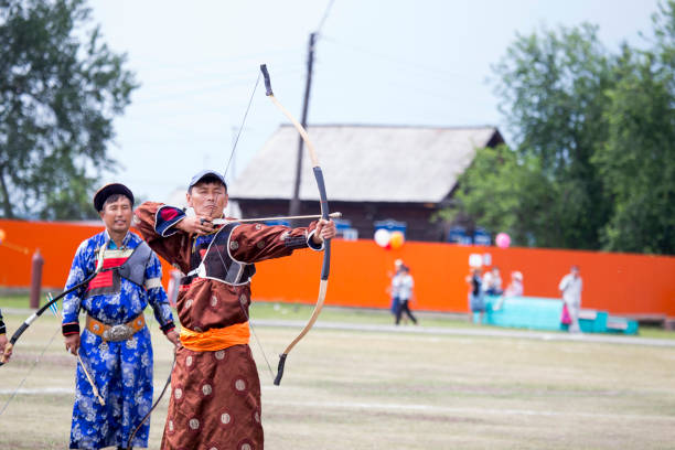 istock Young man shoots from a sports bow 936891160