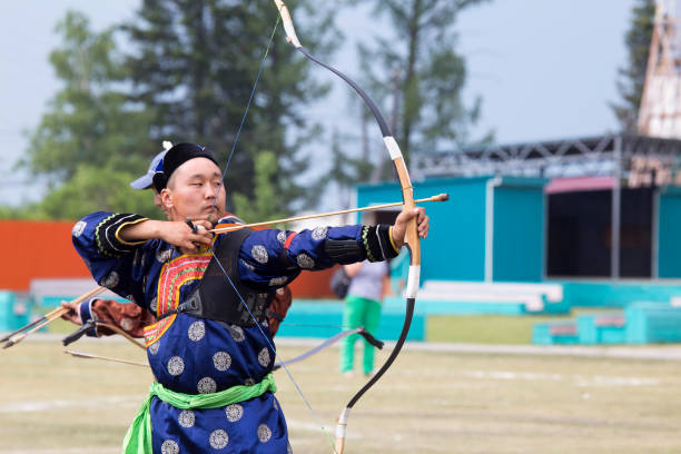 istock Young man shoots from a sports bow 936891172