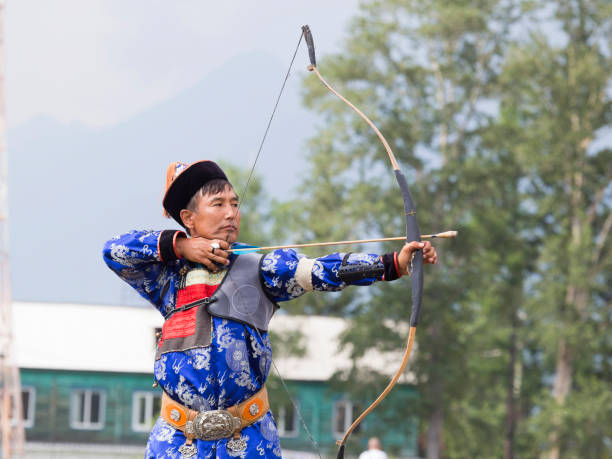 istock Young man shoots from a sports bow 936891268