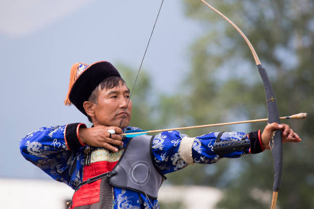 istock Young man shoots from a sports bow 936891276