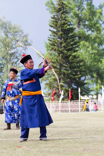 istock Young man shoots from a sports bow 936891340