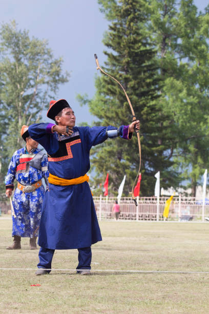 istock Young man shoots from a sports bow 936891400