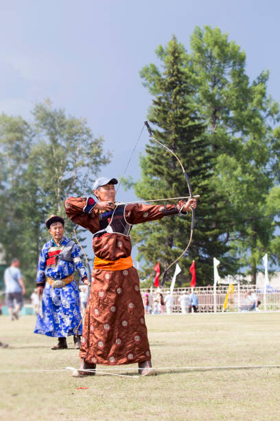 istock Young man shoots from a sports bow 936891414