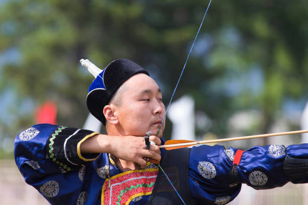 istock Young man shoots from a sports bow 936891480