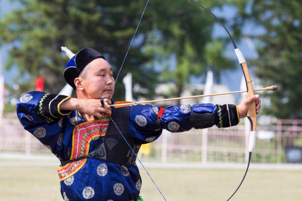 istock Young man shoots from a sports bow 936891492
