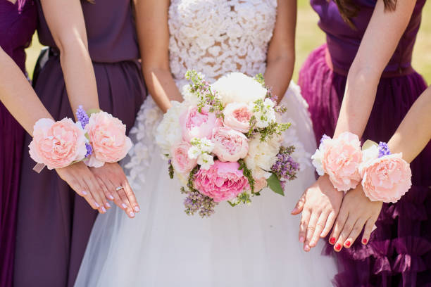 istock Hands of the bride and girlfriend with decorative flowers 936891494