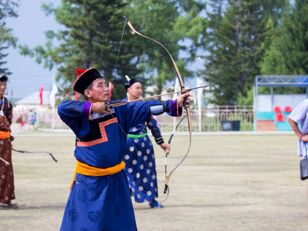 istock Young man shoots from a sports bow 936891532
