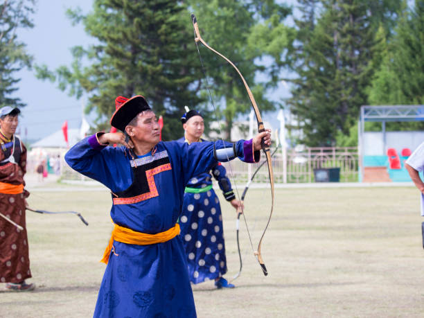 istock Young man shoots from a sports bow 936891722