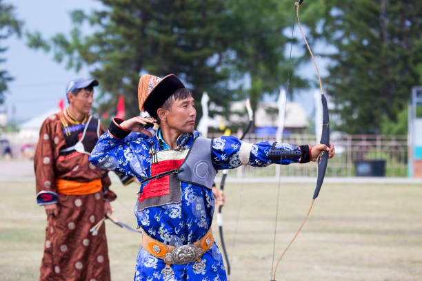 istock Young man shoots from a sports bow 936893584