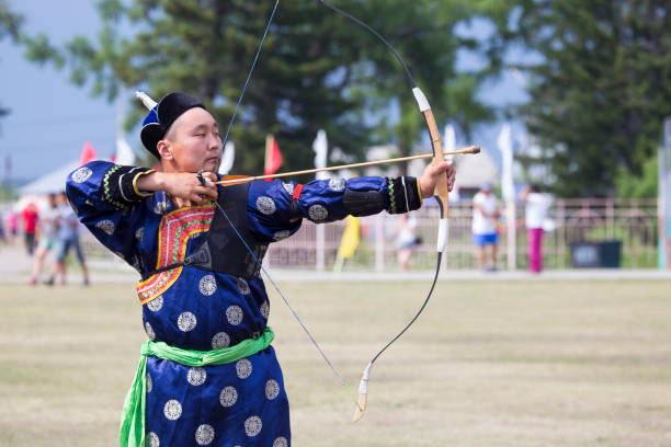istock Young man shoots from a sports bow 936893674