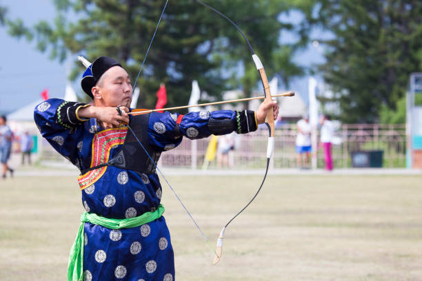 istock Young man shoots from a sports bow 936893678