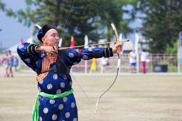 istock Young man shoots from a sports bow 936893688