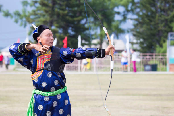 istock Young man shoots from a sports bow 936893716