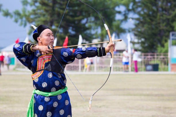istock Young man shoots from a sports bow 936893722