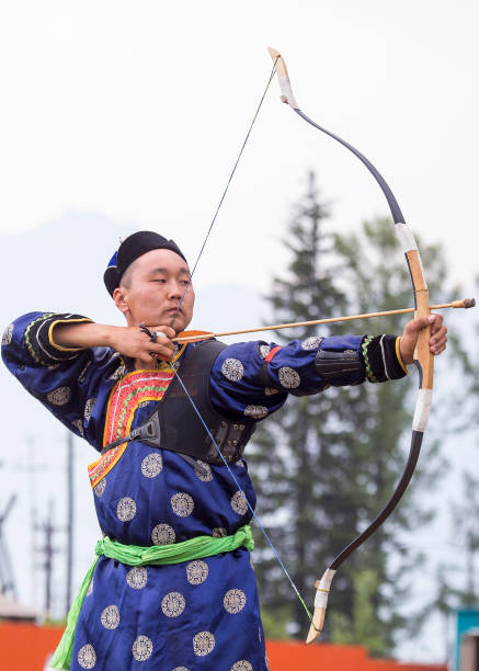 istock Young man shoots from a sports bow 936893798