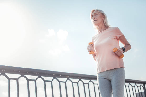 istock Serious aged woman looking straight and running 936893822
