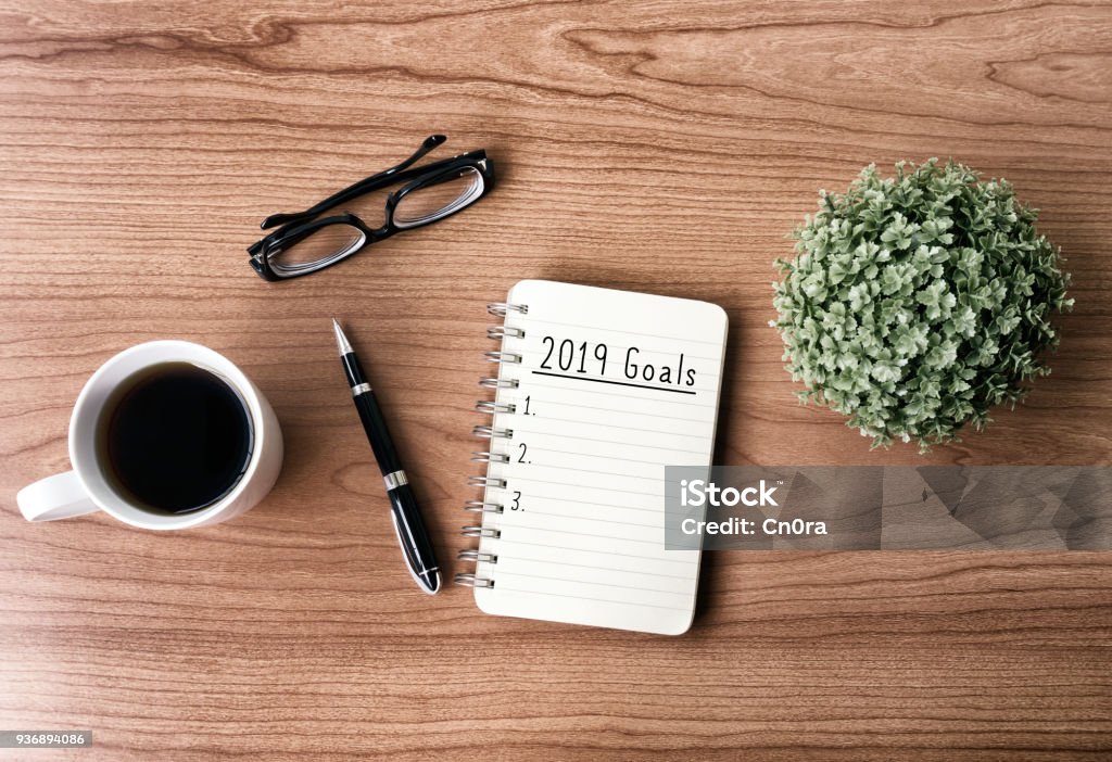 2019 New Year's Goals New year goals and resolution concept - 2019 goals text on notepad. Retro style background. Aspirations Stock Photo